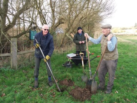 Group of people digging hole