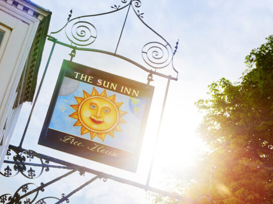 A photo of the pub sign at The Sun Inn